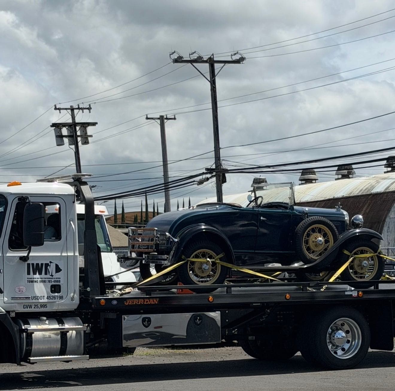 Island Wide Motors flatbed towing a classic convertible